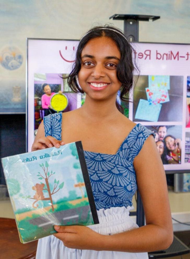 Pratya Poosala holds up a book she created for her self-designed major